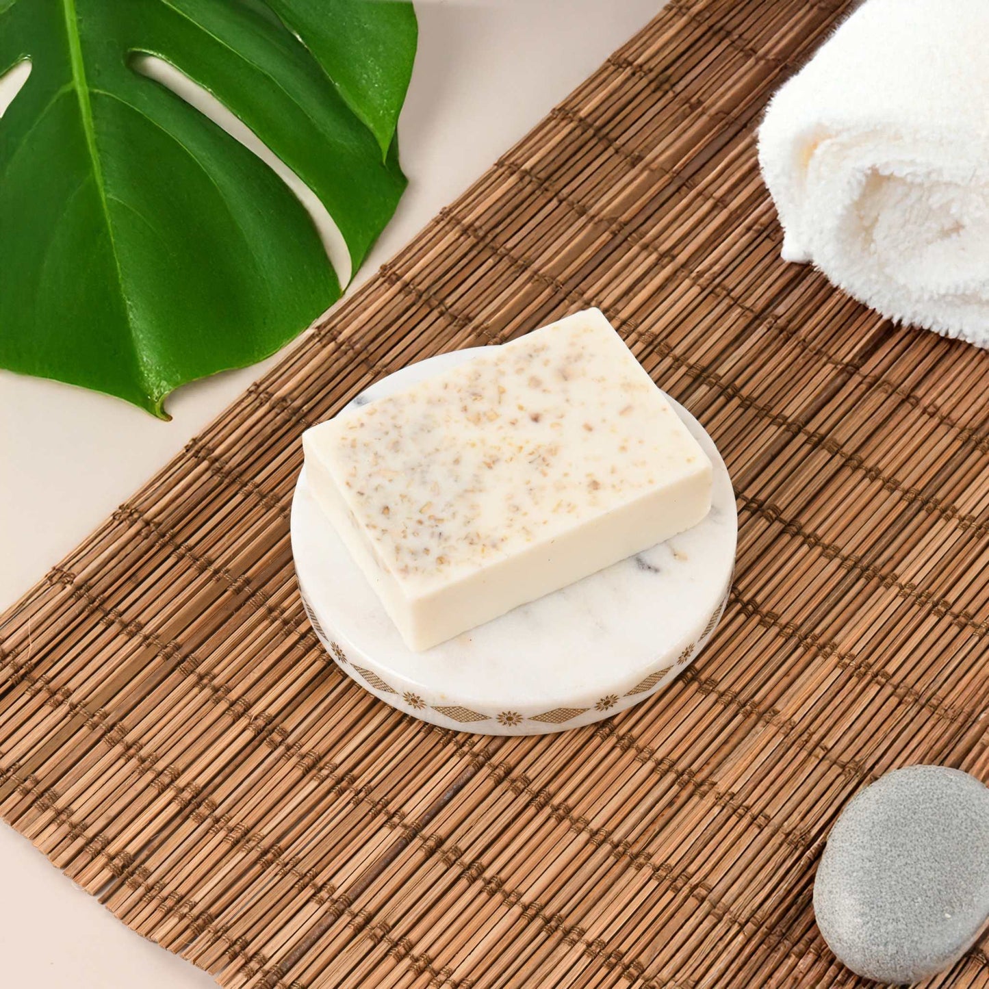 Handmade oatmeal soap bar on a marble dish, ideal for moisturizing and soothing all skin types.