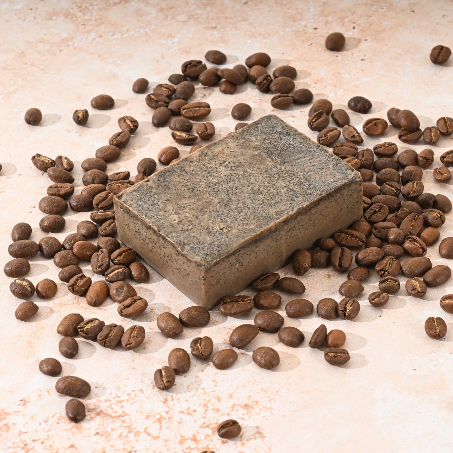Cellulite massager surrounded by coffee beans highlighting natural ingredients for skin firming and cellulite reduction