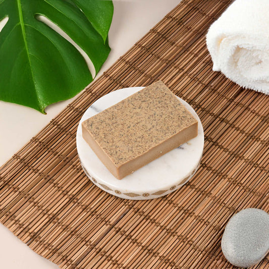 Face Wash for Acne - Daily Cleanser Soap Bar for Oily Skin on bamboo mat with towel and green leaf.