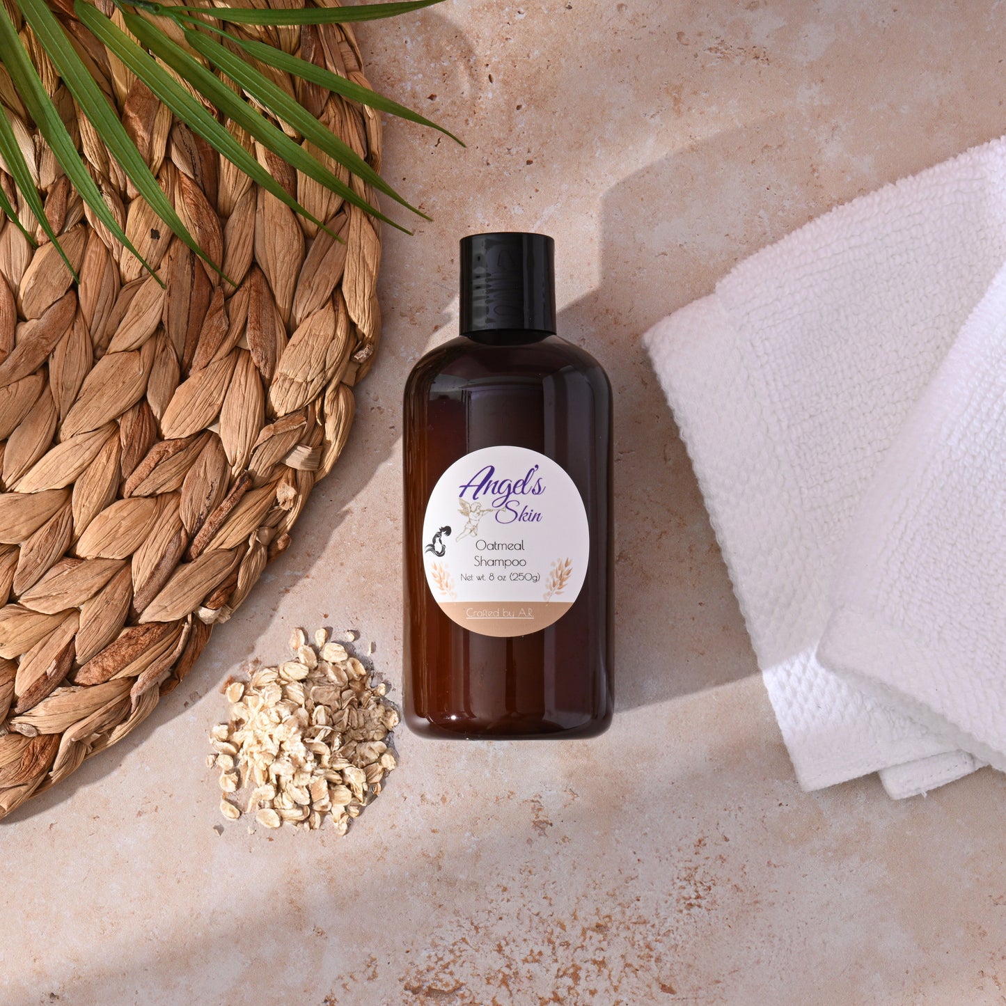 8 oz bottle of Angel's Skin Oatmeal Shampoo, chemical-free moisturizing formula for all hair types, surrounded by oats and towel.